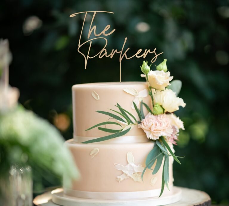 Two-tiered wedding cake with floral decorations and "The Parkers" topper