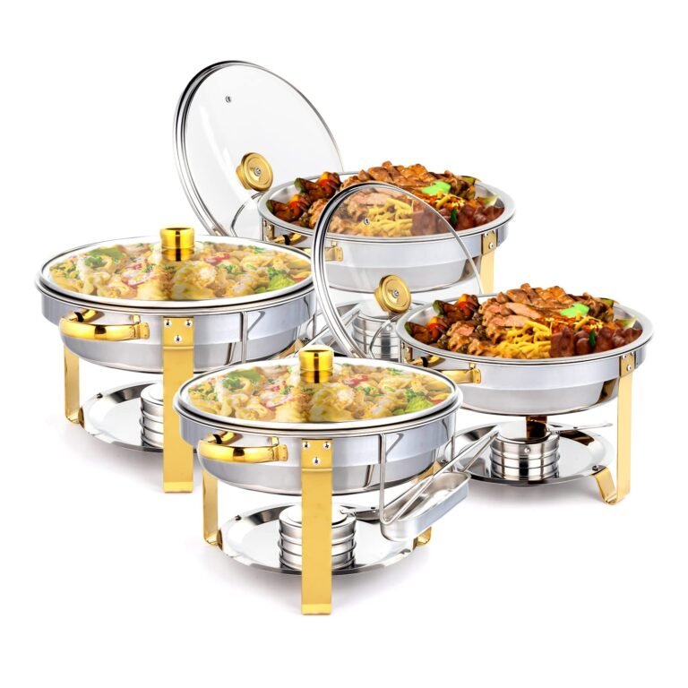 Four stainless steel chafing dishes with food, gold accents, and clear lids