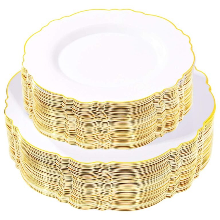 Stacks of white plastic plates with gold scalloped edges