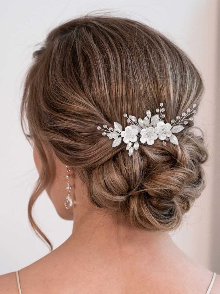 Woman's updo hairstyle with floral hair comb and dangling earrings