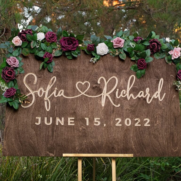 Wooden wedding sign with names, date, and floral garland